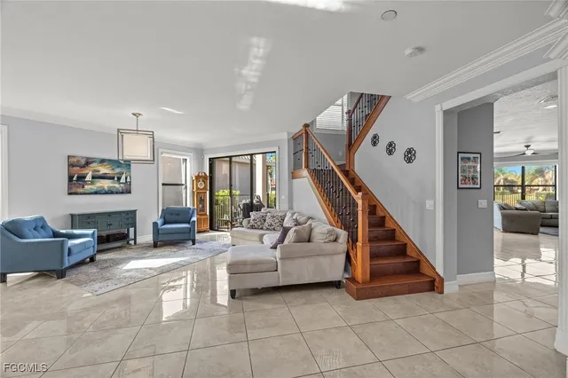a living room with furniture and stairs