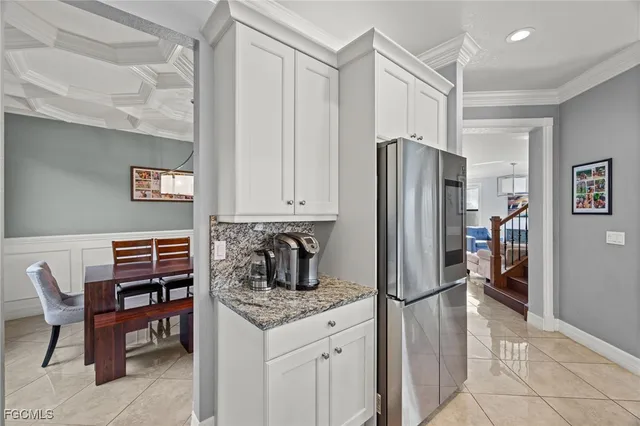 a kitchen with stainless steel appliances granite countertop a refrigerator and a stove top oven