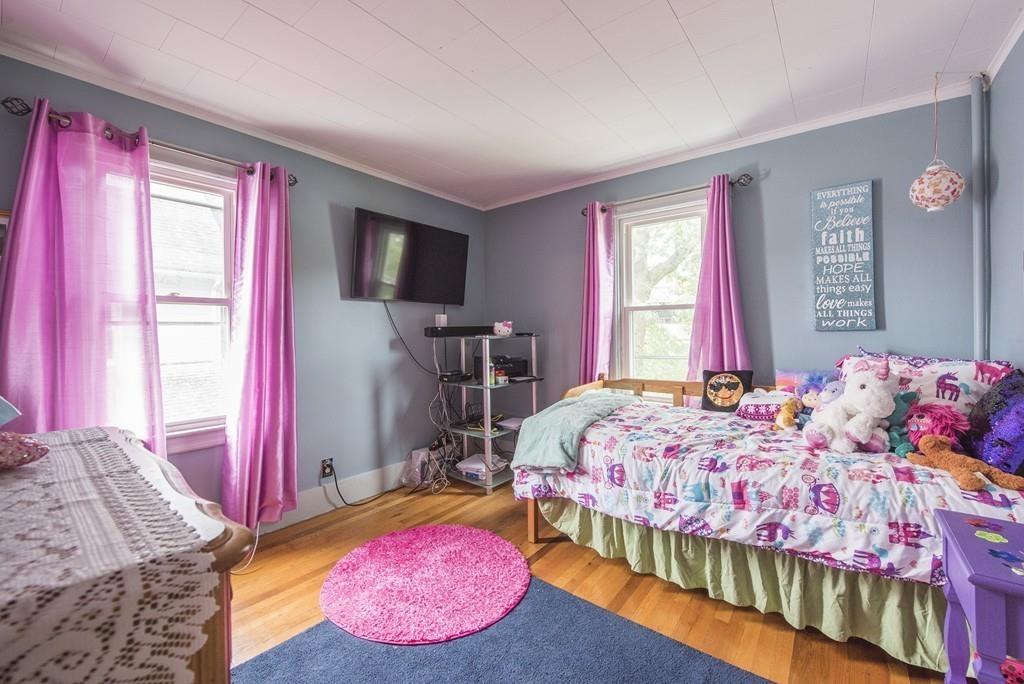 46 Parkside Street Springfield, MA 01104 - Photo 16 of 23 a bedroom with a bed and wooden floor