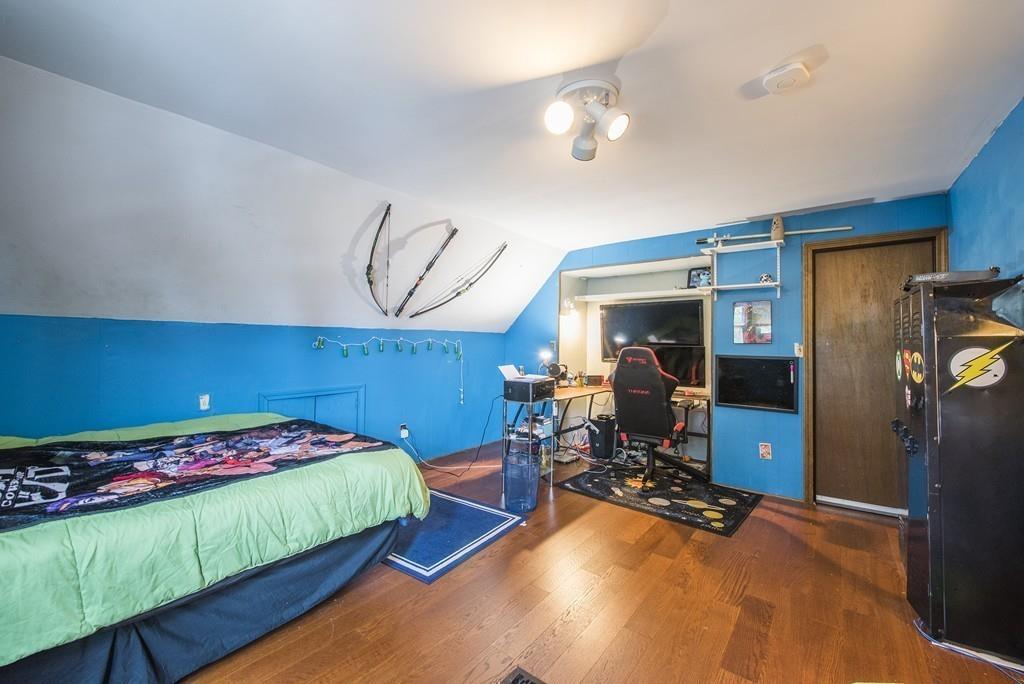 46 Parkside Street Springfield, MA 01104 - Photo 19 of 23 a bedroom with a bed and wooden floor