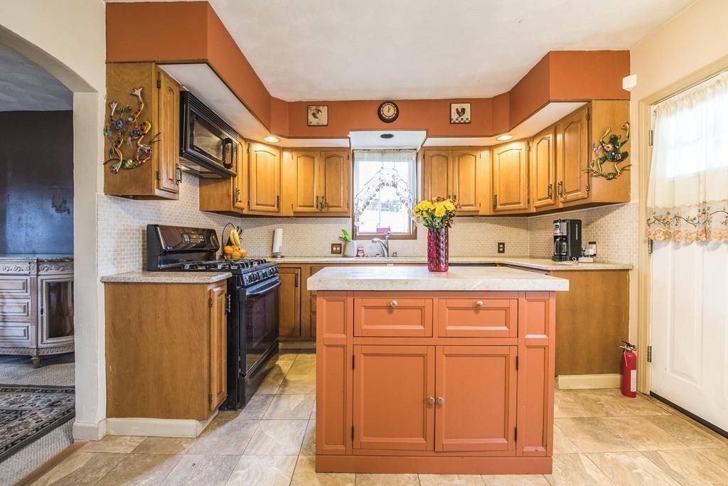 46 Parkside Street Springfield, MA 01104 - Photo 3 of 23 a kitchen with stainless steel appliances granite countertop a sink and cabinets