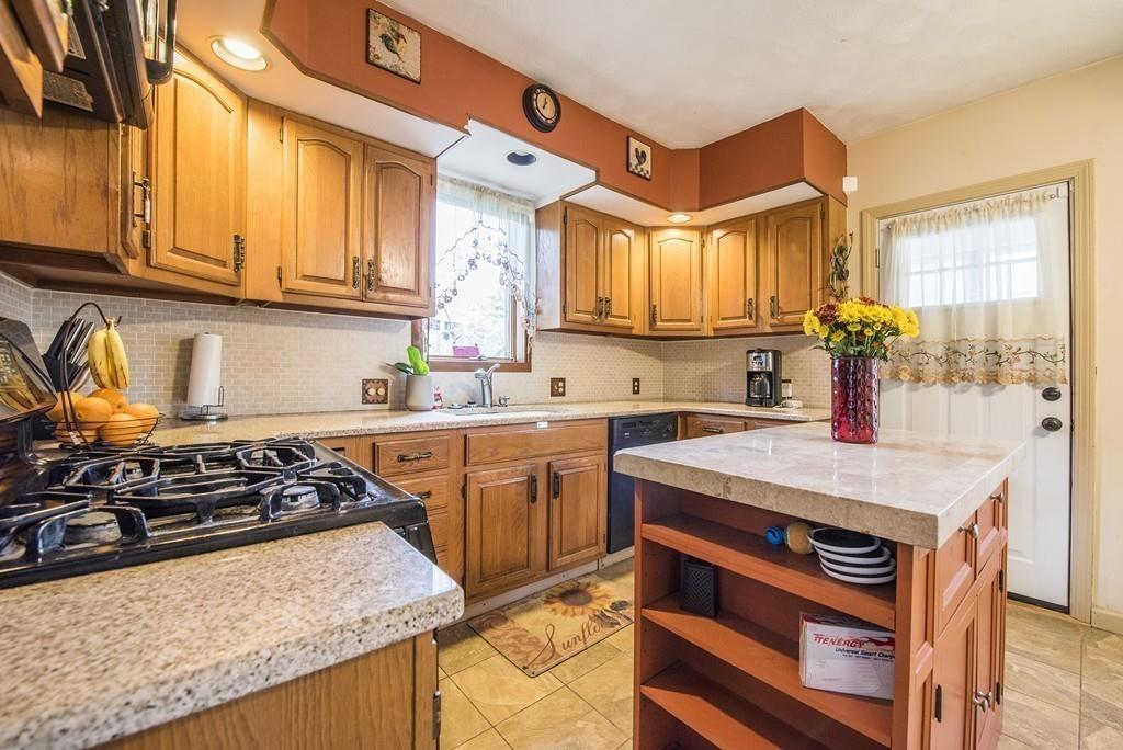 46 Parkside Street Springfield, MA 01104 - Photo 6 of 23 a kitchen with stainless steel appliances granite countertop a stove and a sink