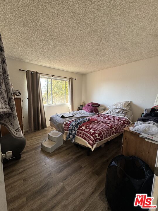 1724 Broadway Street Oceanside, CA 92054 - Photo 14 of 19 a bedroom with a bed and a dresser next to a window