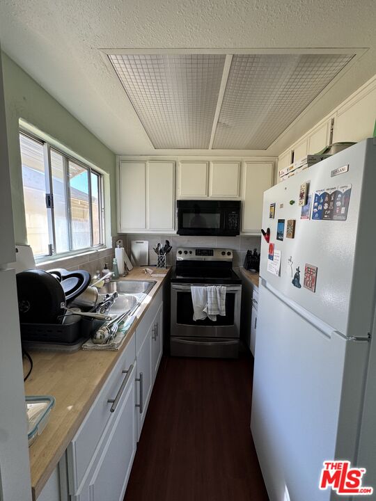 1724 Broadway Street Oceanside, CA 92054 - Photo 9 of 19 a kitchen with a sink a stove and a refrigerator