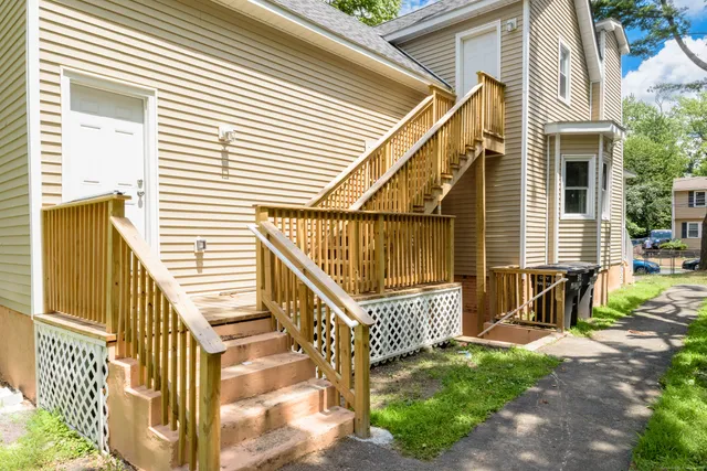 a view of two chairs and table in the patio