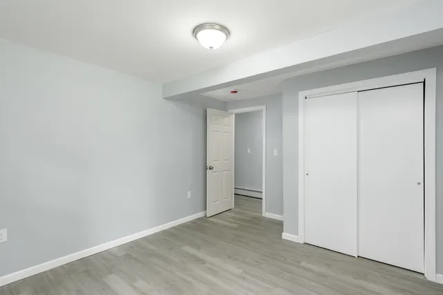 a view of an empty room and wooden floor