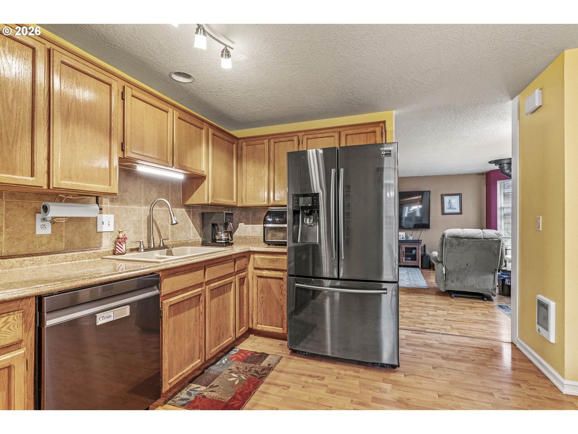 1102 South 11th Avenue Kelso, WA 98626 - Photo 11 of 32 a kitchen with stainless steel appliances granite countertop a refrigerator a sink and a stove