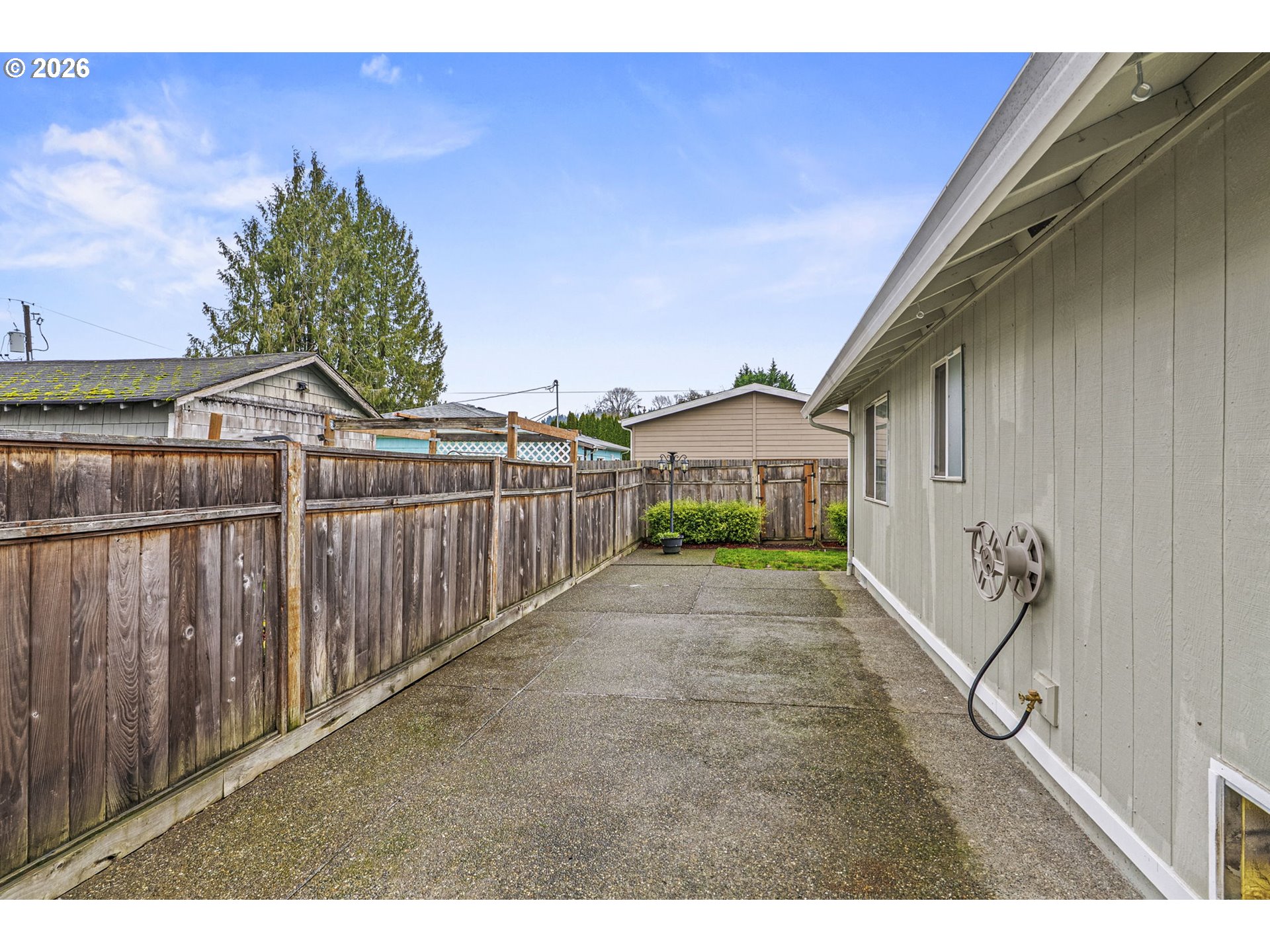 1102 South 11th Avenue Kelso, WA 98626 - Photo 23 of 32 a view of a street with a small yard and wooden fence