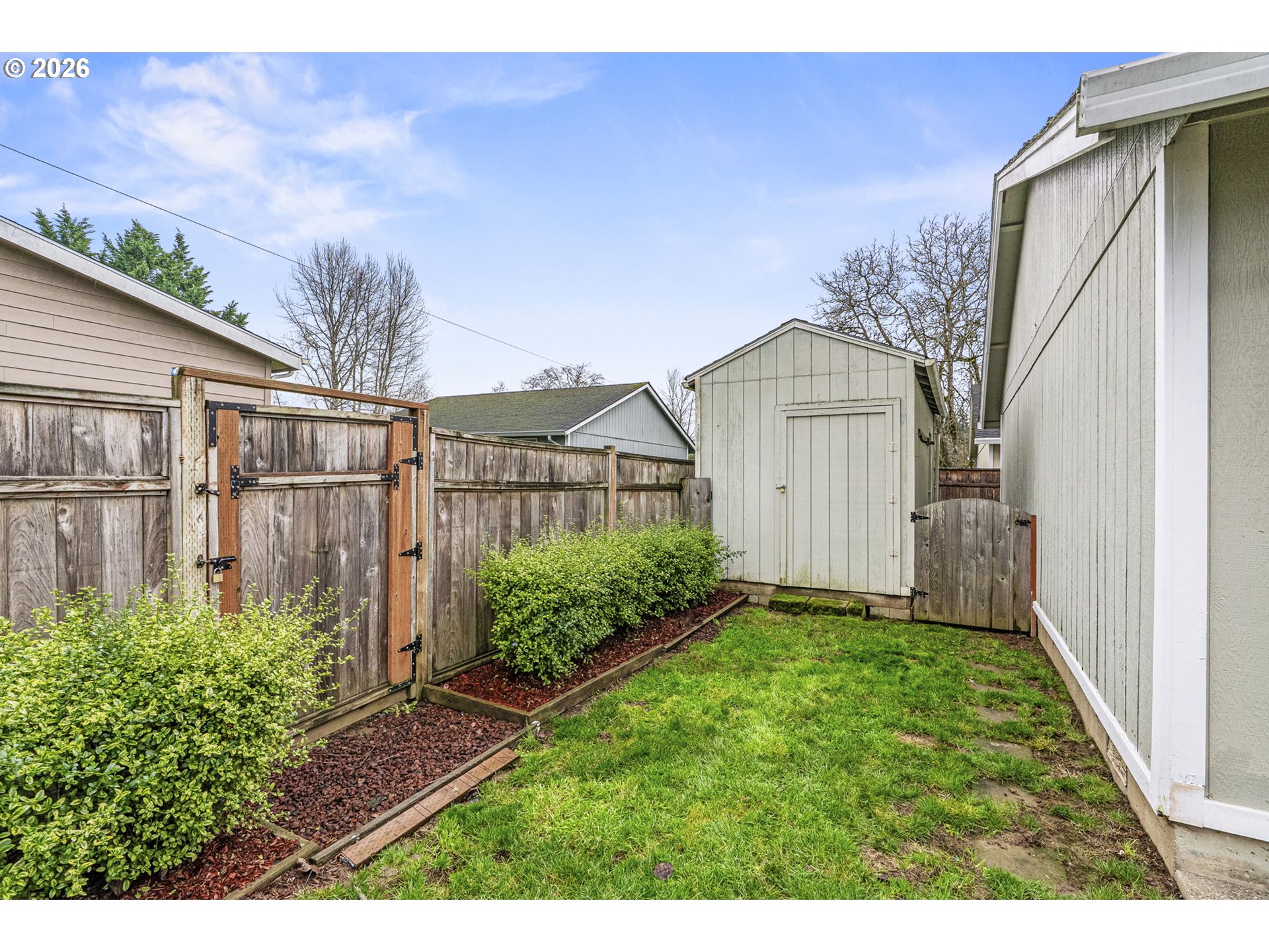 1102 South 11th Avenue Kelso, WA 98626 - Photo 25 of 32 a view of backyard with potted plants and wooden fence