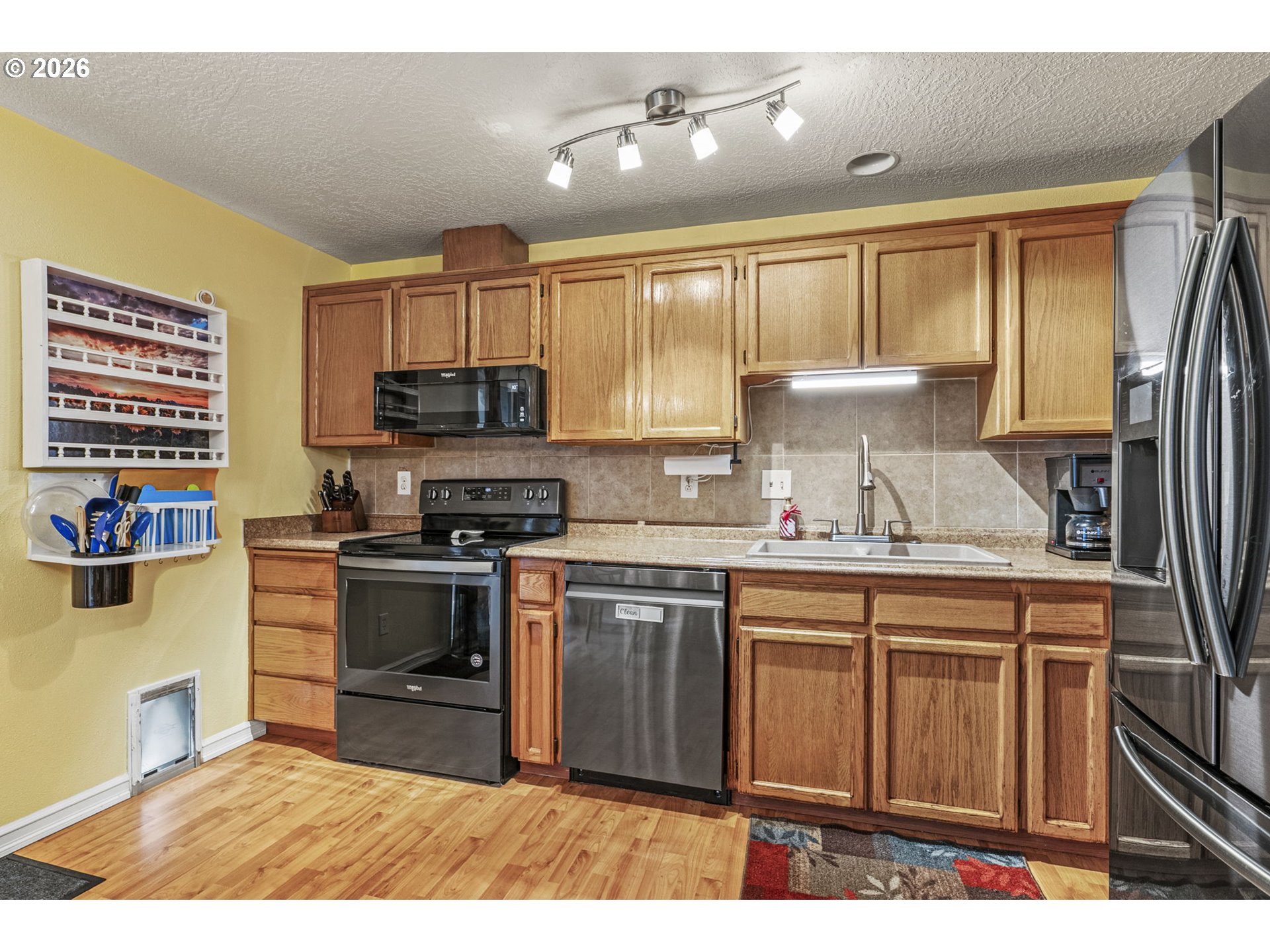 1102 South 11th Avenue Kelso, WA 98626 - Photo 10 of 32 a kitchen with stainless steel appliances granite countertop a stove a sink dishwasher and a refrigerator