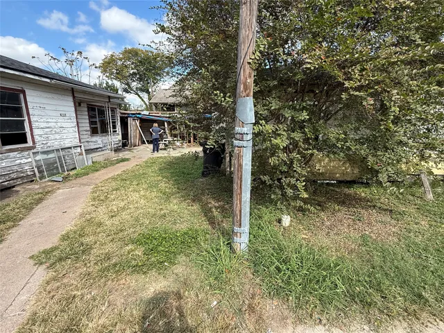 a view of a house with a tree in the background