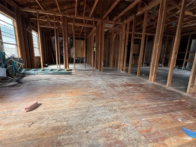 a view of a room with wooden floor