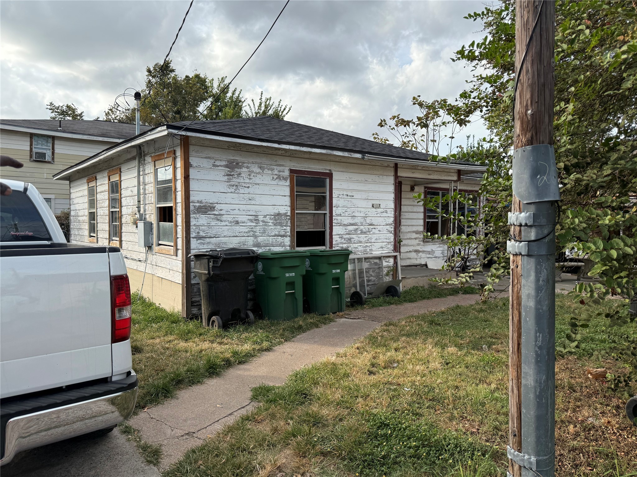 4011-4017 Terry Street Houston, TX 77009 - Photo 5 of 48 a view of a house with a small yard and a large tree