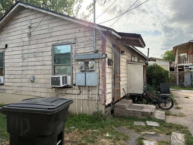 a view of house with backyard outdoor seating and barbeque oven
