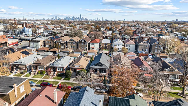 an aerial view of multiple houses with yard