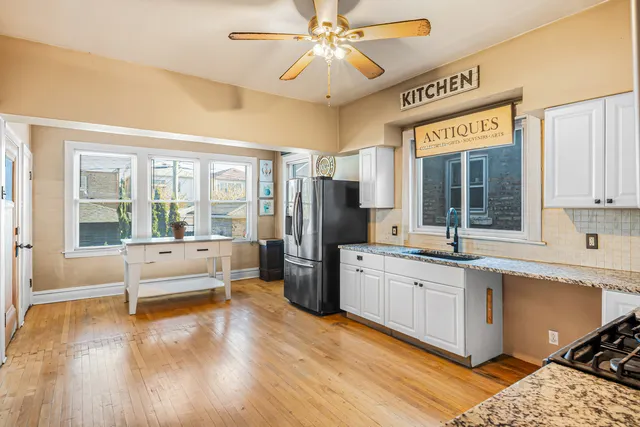 a large white kitchen with a large window