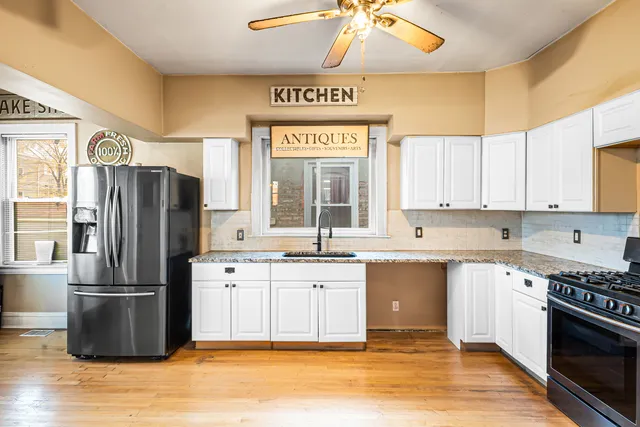 a kitchen with stainless steel appliances granite countertop a refrigerator and a sink