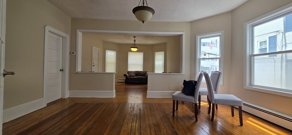 105 6th Street, Unit 1 Fall River, MA 02721 - Photo 7 of 8 a view of a dining room with furniture window and wooden floor