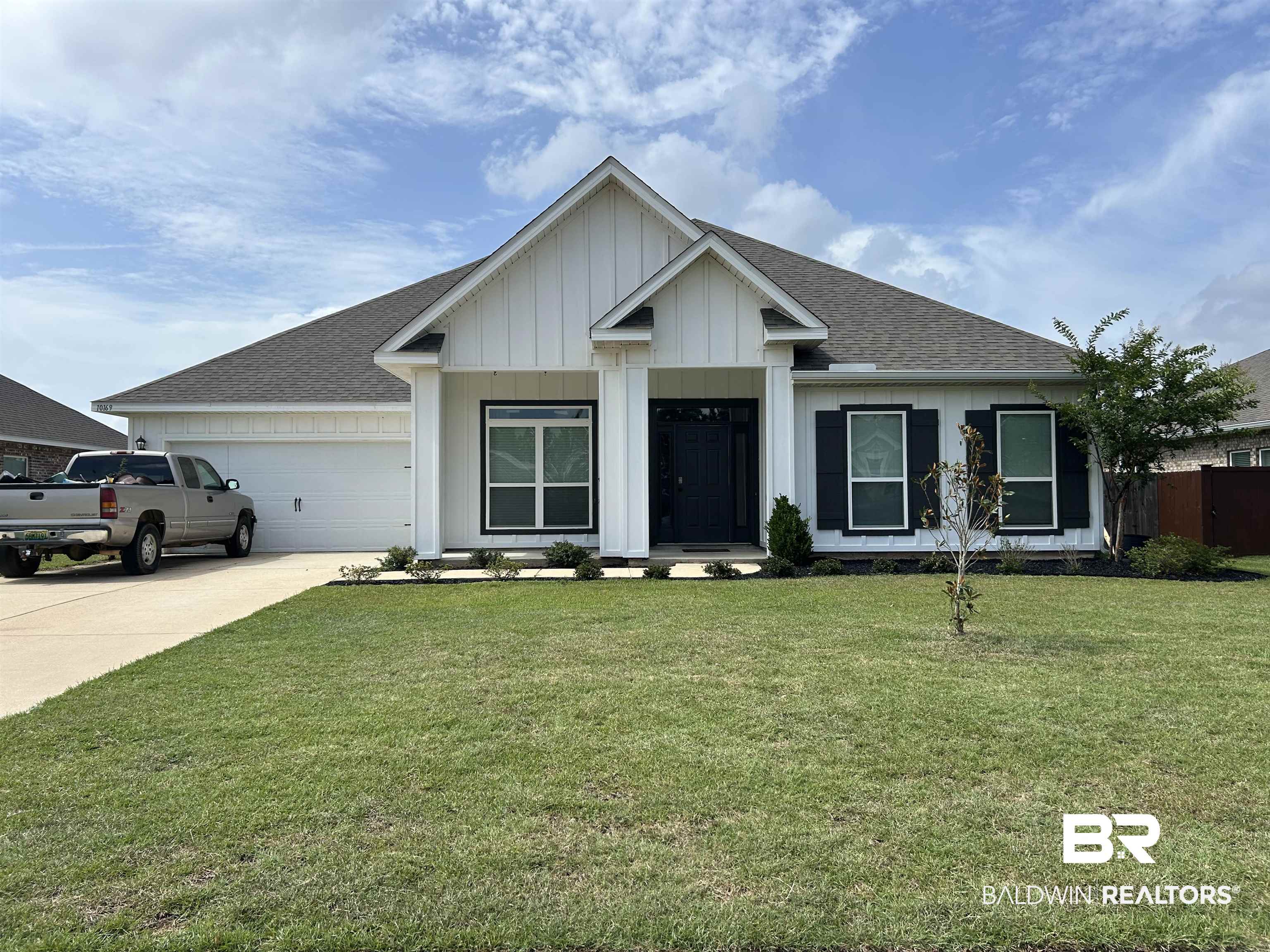 10169 Dunleith Loop Daphne, AL 36526 - Photo 1 of 40 View of front of home with a shingled roof, concrete driveway, an attached garage, and board and batten siding