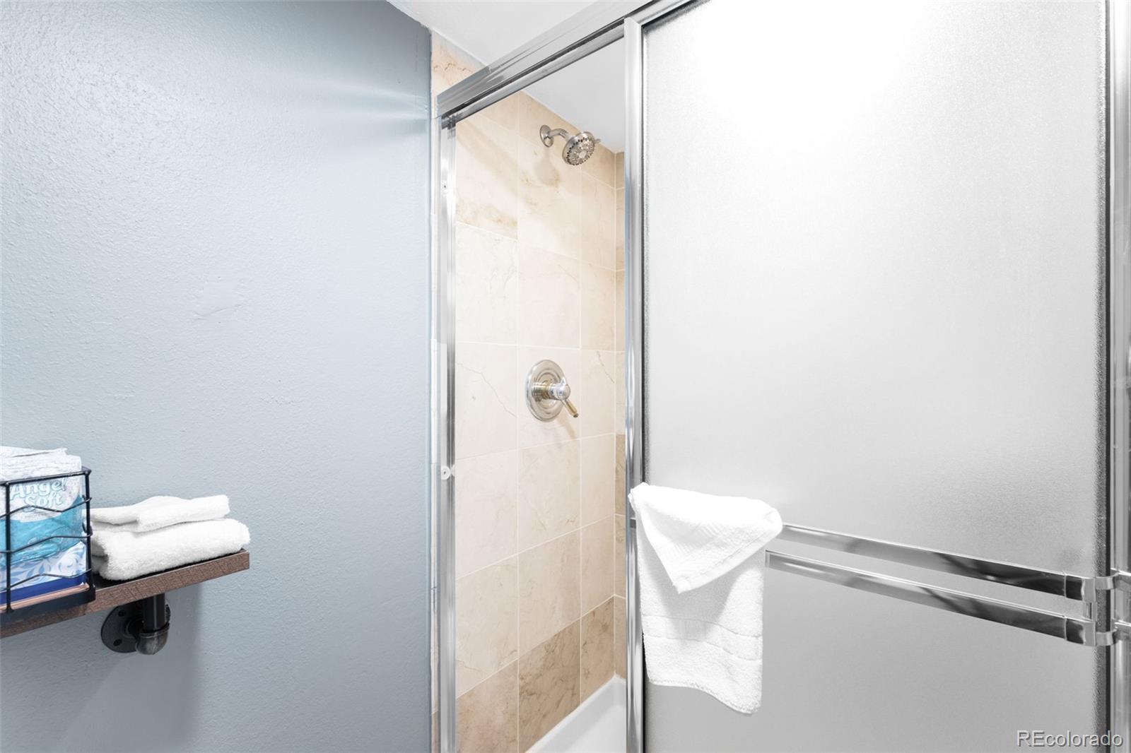 760 Copper Road, Unit F204 Frisco, CO 80443 - Photo 18 of 30 a bathroom with a toilet and a shower