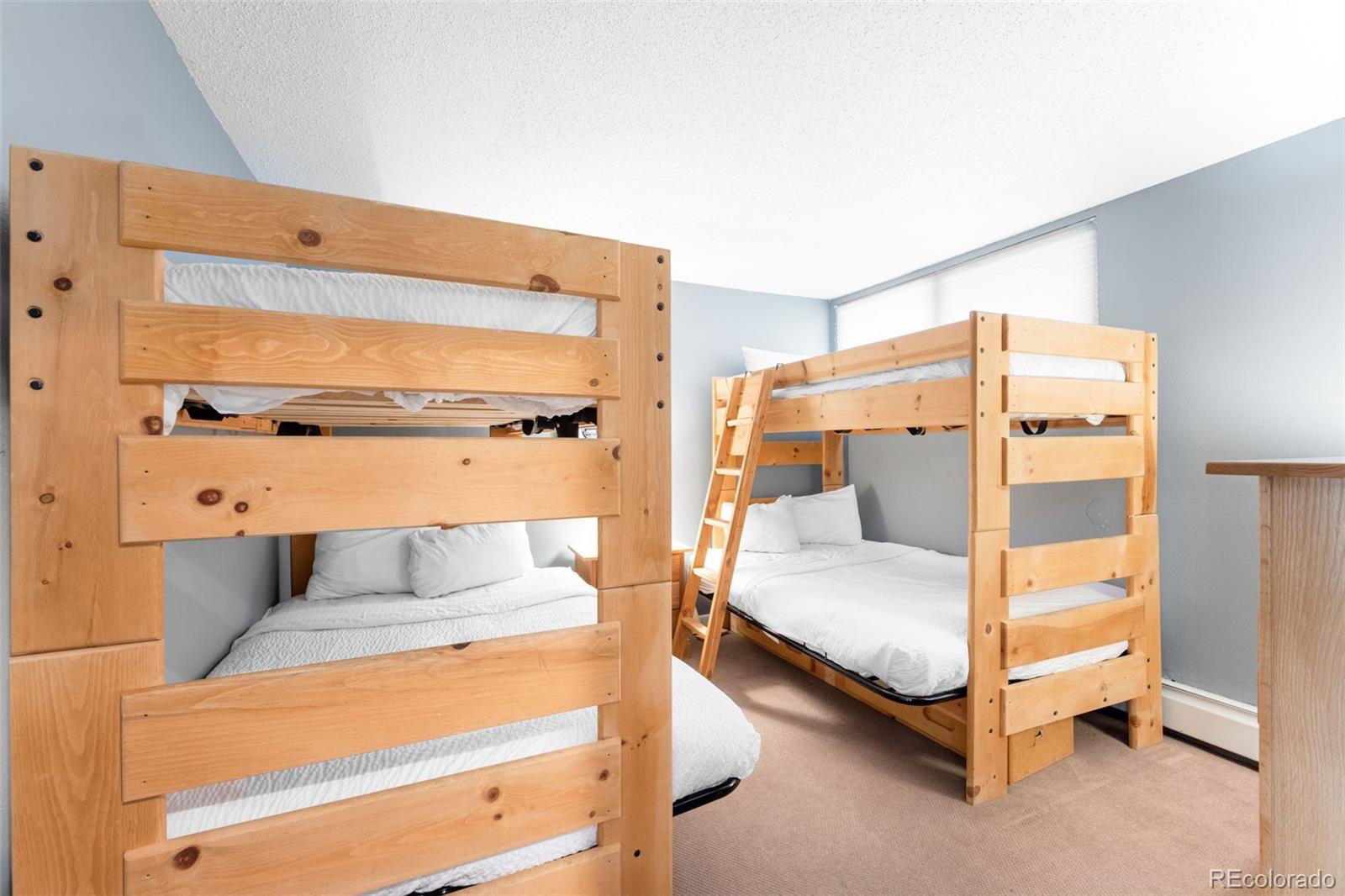 760 Copper Road, Unit F204 Frisco, CO 80443 - Photo 19 of 30 a bedroom with a bed and window