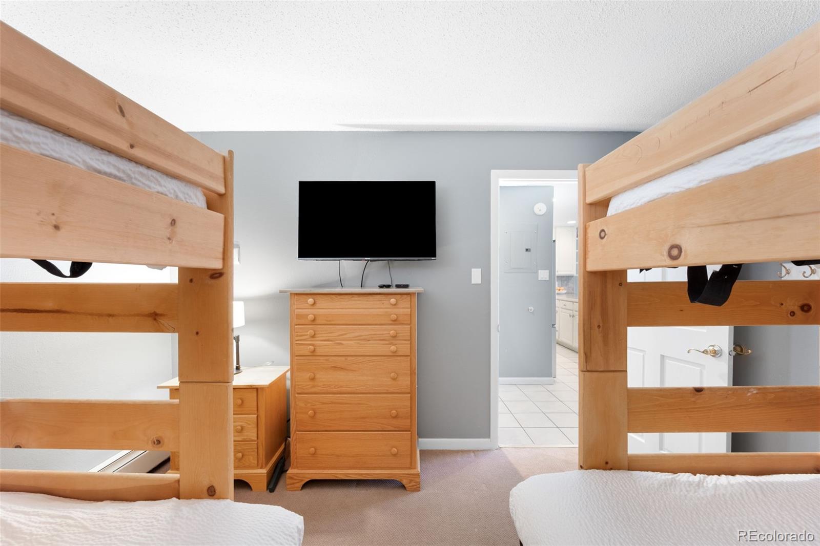 760 Copper Road, Unit F204 Frisco, CO 80443 - Photo 20 of 30 a living room with furniture and a flat screen tv