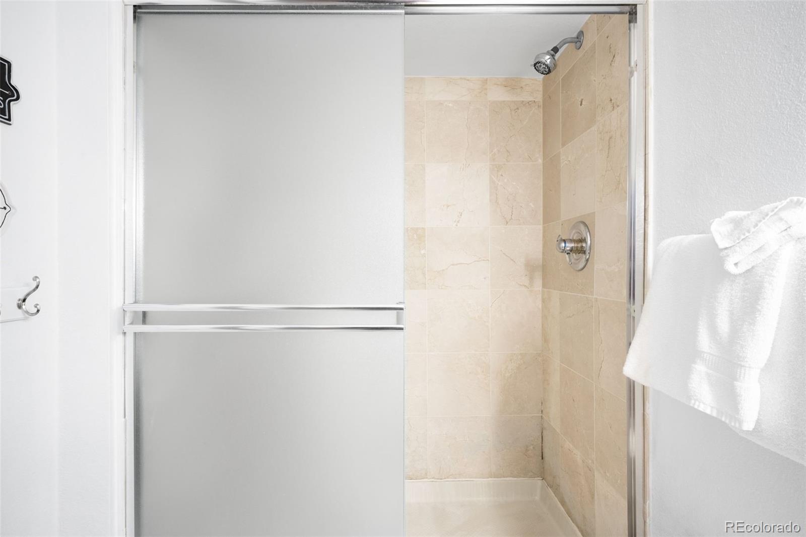 760 Copper Road, Unit F204 Frisco, CO 80443 - Photo 22 of 30 a bathroom with a glass shower door