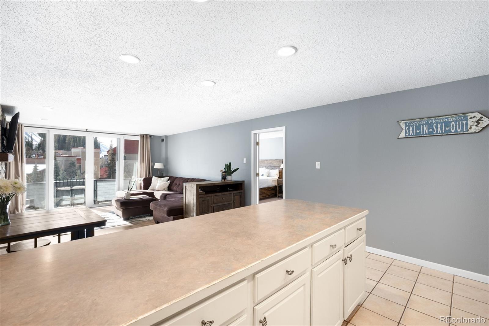 760 Copper Road, Unit F204 Frisco, CO 80443 - Photo 7 of 30 a living room with furniture and large windows