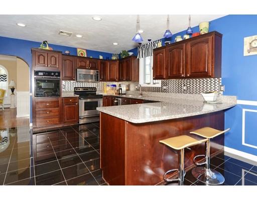 38 Thoreau Circle Beverly, MA 01915 - Photo 12 of 26 a kitchen with stainless steel appliances granite countertop a sink a stove a refrigerator cabinets and dining table