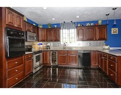 38 Thoreau Circle Beverly, MA 01915 - Photo 14 of 26 a kitchen with stainless steel appliances granite countertop a stove a sink and a microwave