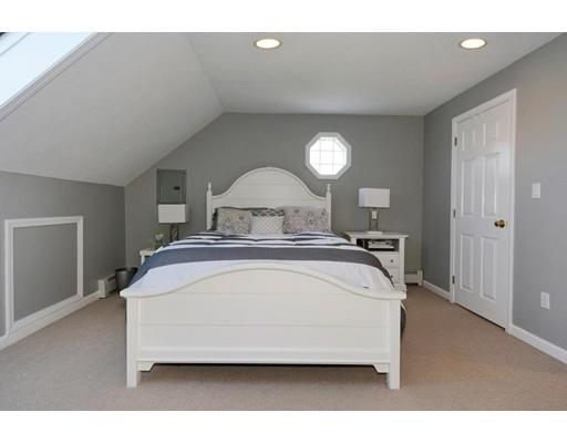 38 Thoreau Circle Beverly, MA 01915 - Photo 23 of 26 a spacious bedroom with a bed and a potted plant