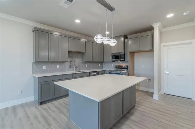 a kitchen with a stove a sink and a refrigerator