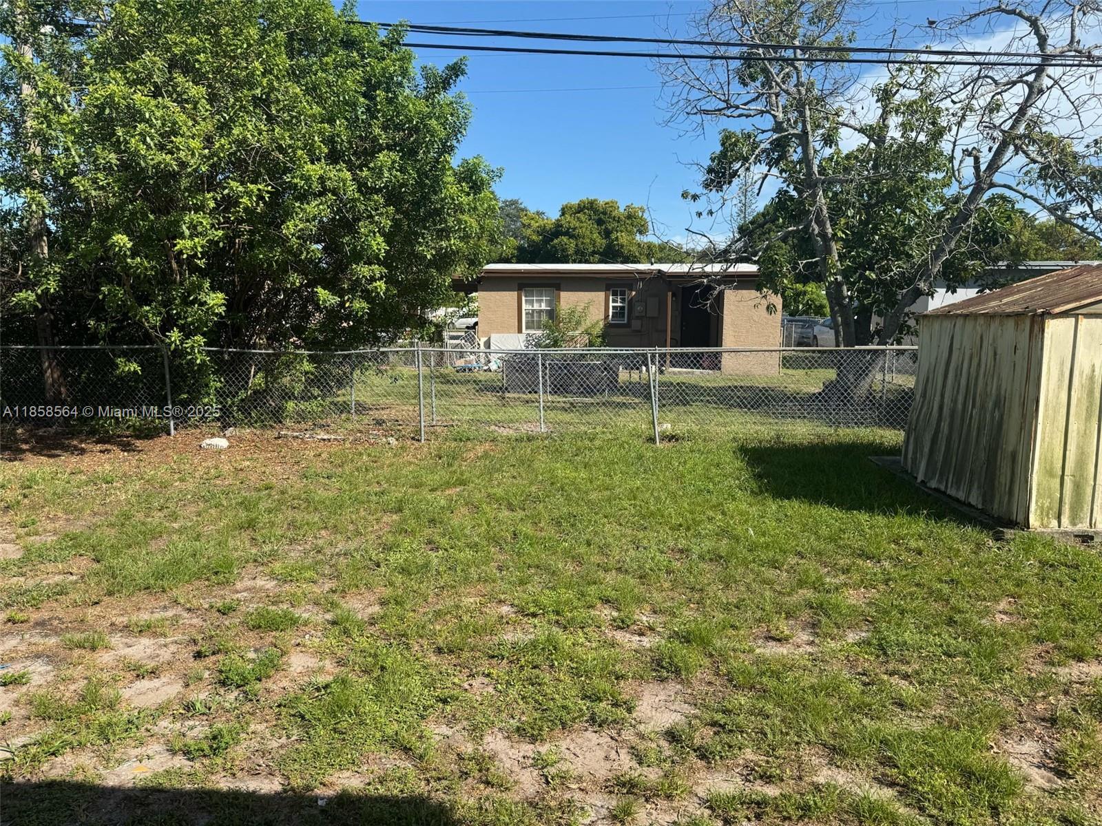 2060 Rutland Street Opa-Locka, FL 33054 - Photo 2 of 10 a backyard of a house with lots of green space