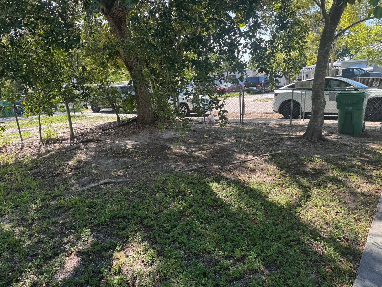 2060 Rutland Street Opa-Locka, FL 33054 - Photo 7 of 10 a view of a yard with plants and a large tree