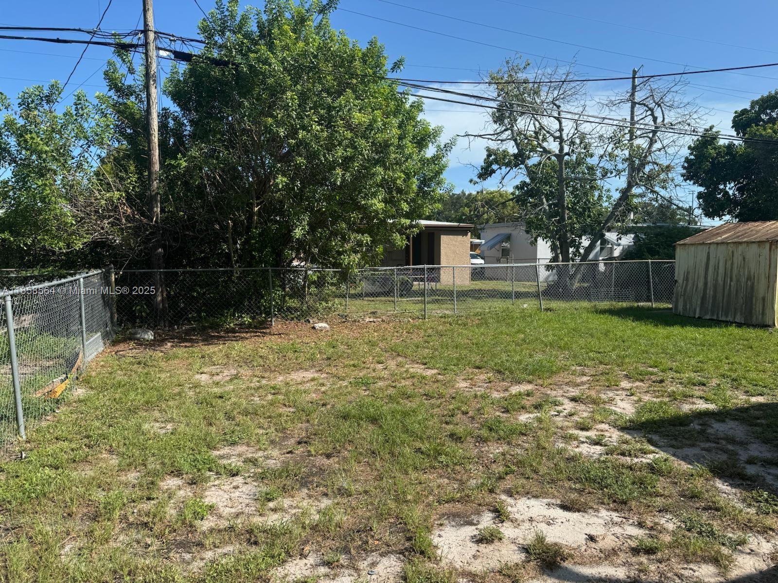 2060 Rutland Street Opa-Locka, FL 33054 - Photo 8 of 10 a backyard of a house with lots of green space