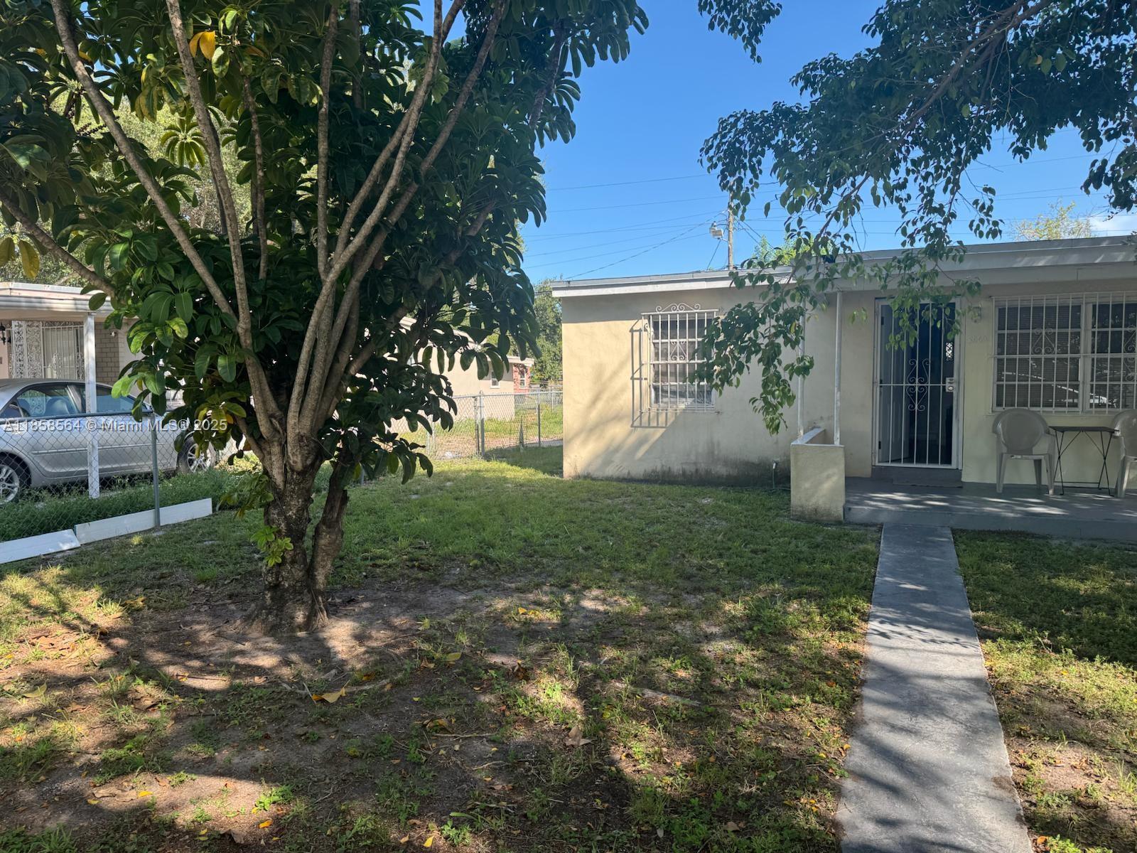 2060 Rutland Street Opa-Locka, FL 33054 - Photo 9 of 10 a view of a house with yard and a garden