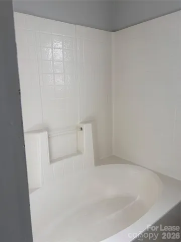 a white bath tub sitting in a bathroom