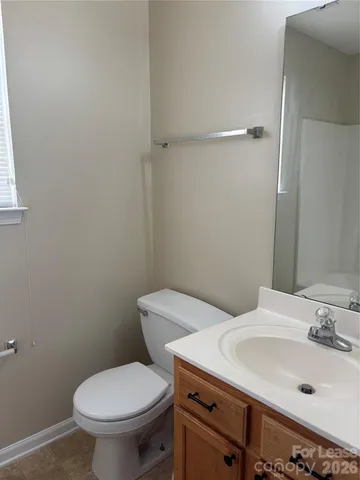 a white toilet sitting next to a bathroom sink