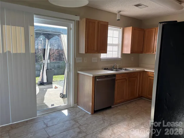 a kitchen with a sink a stove cabinets and a refrigerator