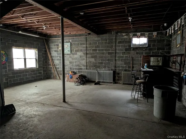 a view of empty room with wooden floor and windows