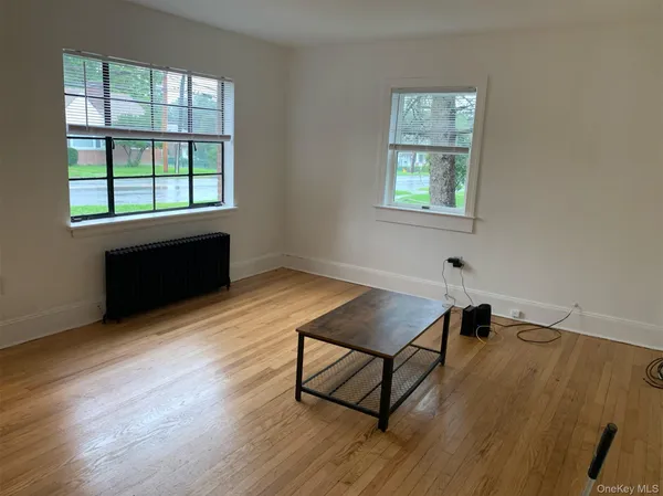 a living room with a bed furniture and a window