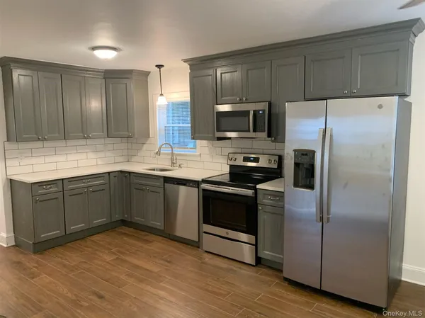 a kitchen with a refrigerator sink and microwave