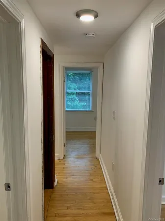 a view of hallway with wooden floor