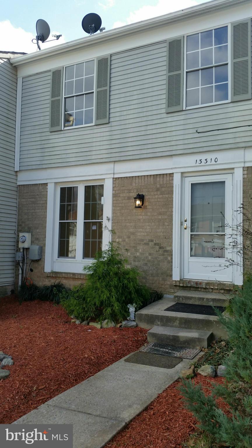 13310 Country Ridge Drive Germantown, MD 20874 - Photo 2 of 26 a front view of a house with a yard