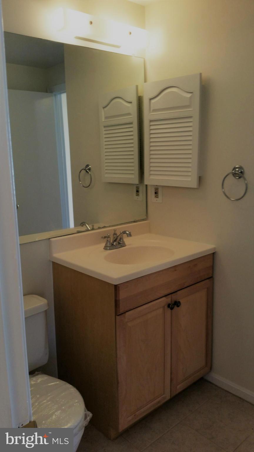 13310 Country Ridge Drive Germantown, MD 20874 - Photo 15 of 26 a bathroom with a sink toilet and mirror