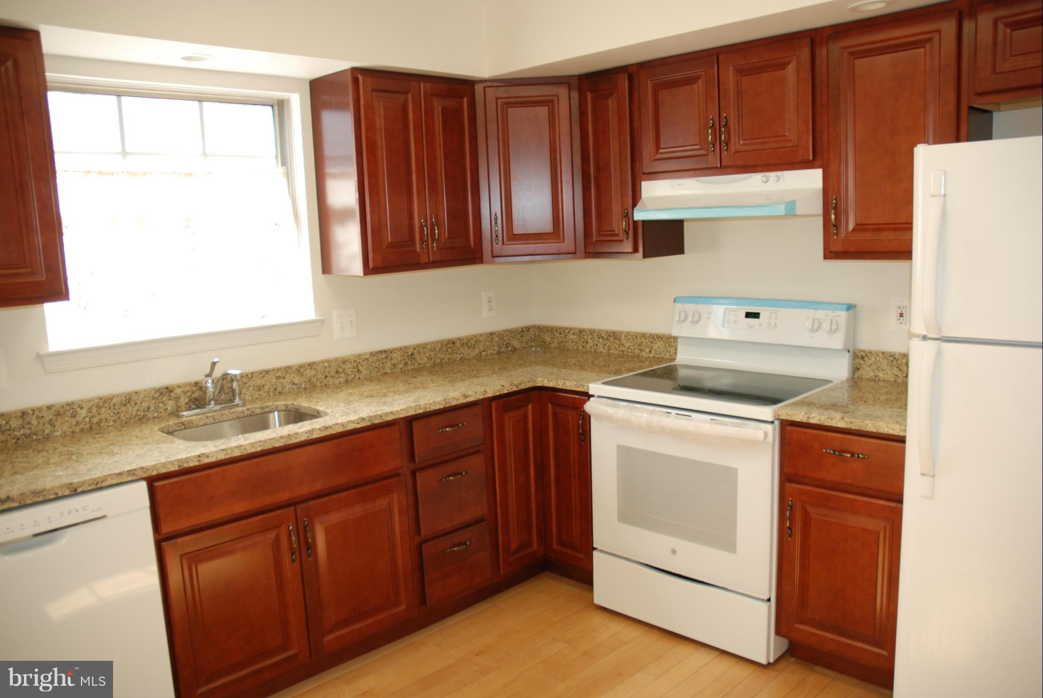 13310 Country Ridge Drive Germantown, MD 20874 - Photo 3 of 26 a kitchen with a sink stove and cabinets