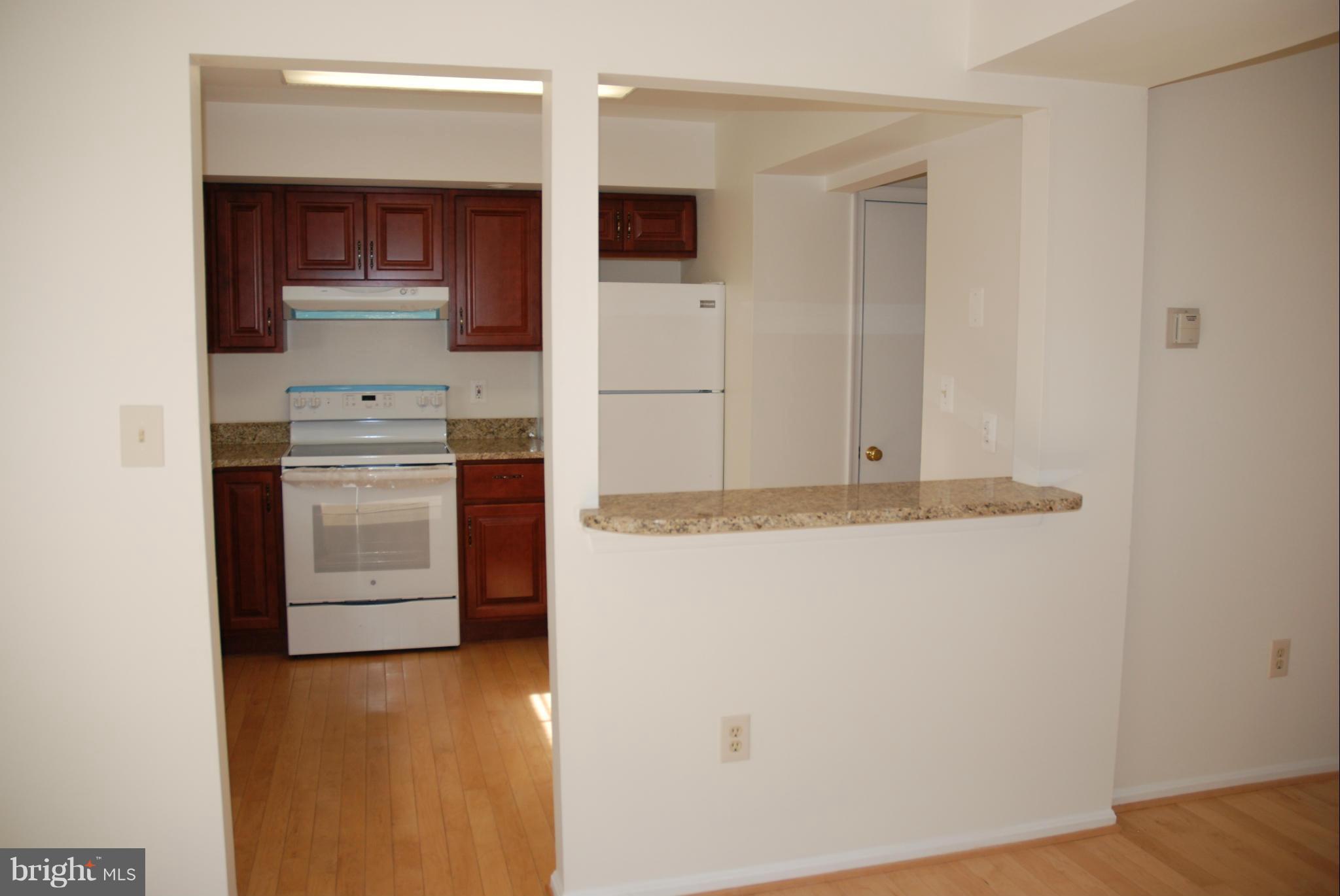 13310 Country Ridge Drive Germantown, MD 20874 - Photo 4 of 26 a kitchen with stainless steel appliances granite countertop a stove and a refrigerator