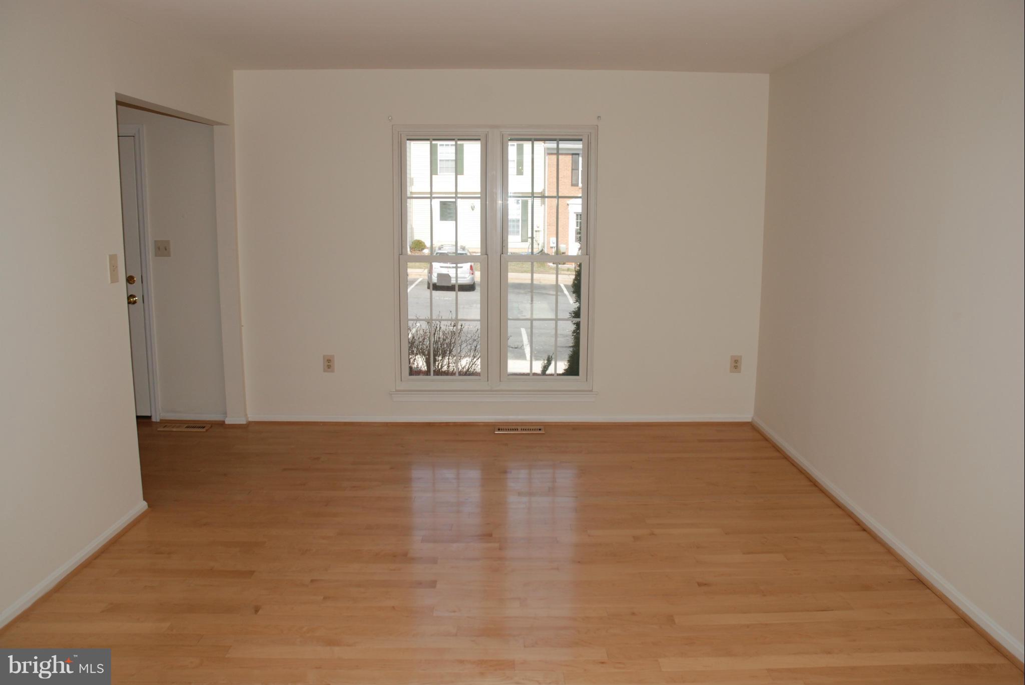 13310 Country Ridge Drive Germantown, MD 20874 - Photo 8 of 26 an empty room with wooden floor and windows