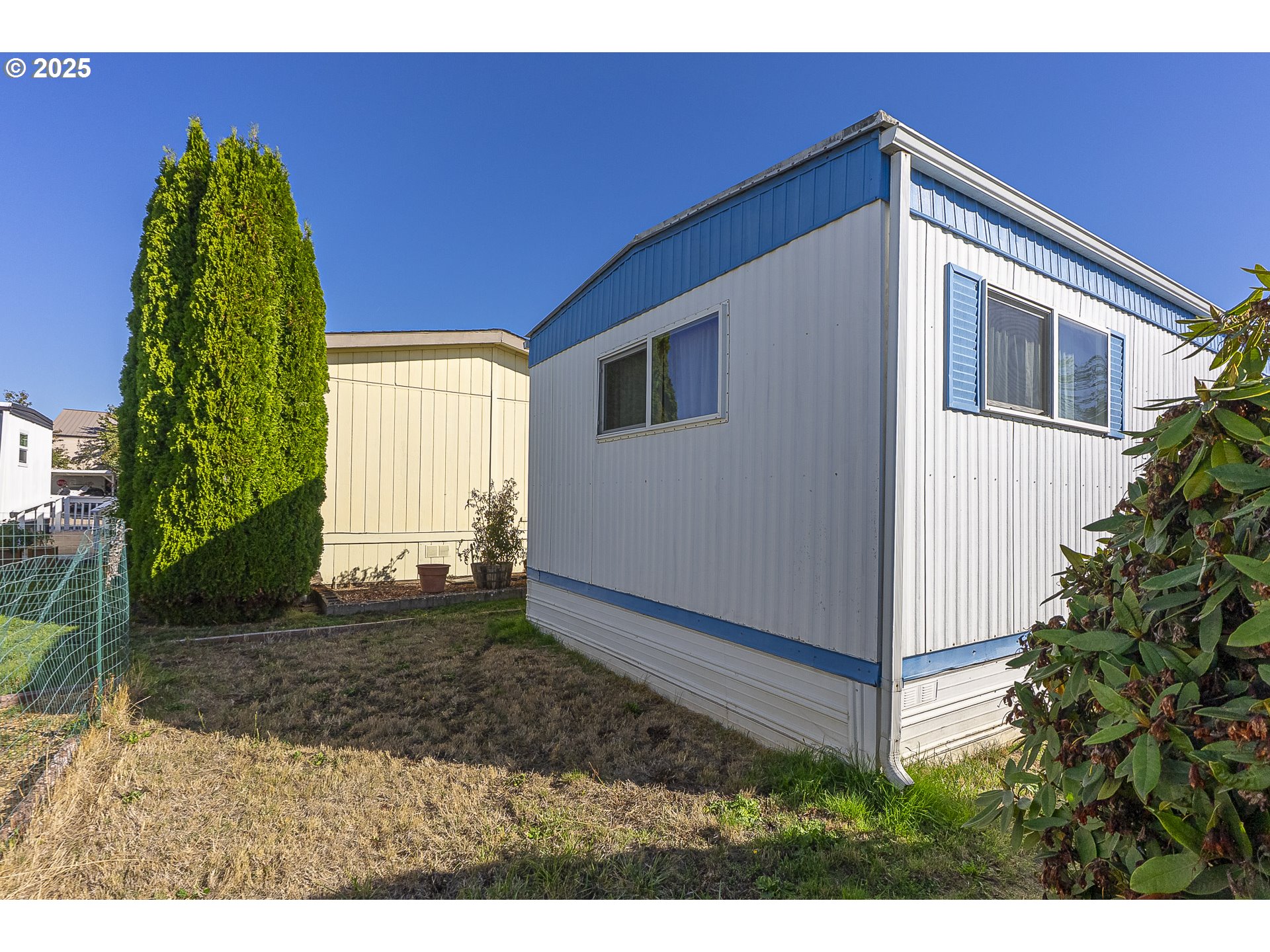 2150 Laura Street, Unit 57 Springfield, OR 97477 - Photo 13 of 23 a front view of a house with a yard