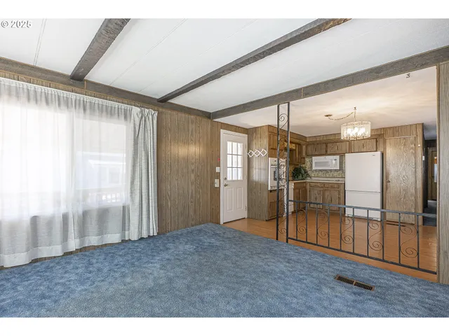 a view of an empty room and floor to ceiling window
